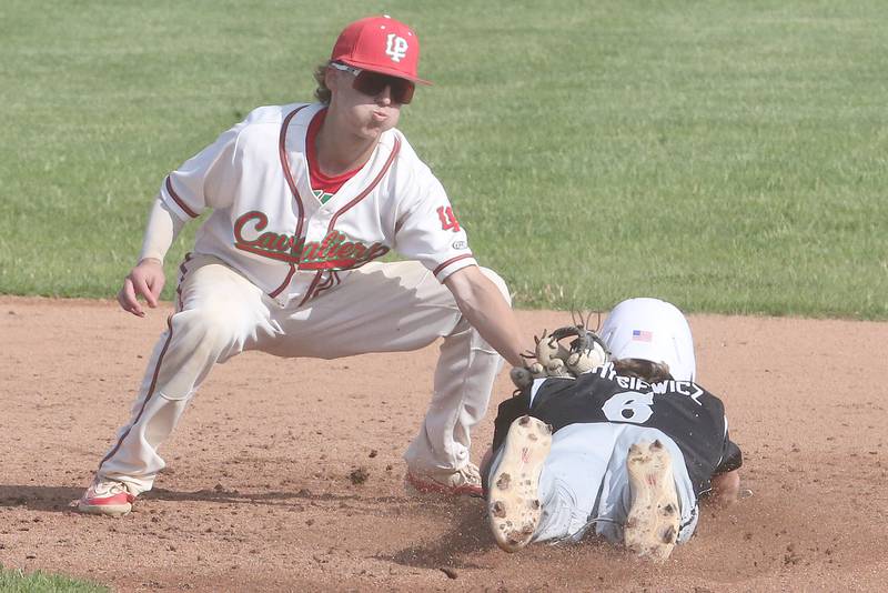 L-P's Grey Ernat tags out Kaneland's Dylan Borysiewicz attempting to steal second base against Kaneland on Tuesday, May 13, 2025 at Huby Sarver Field at the L-P Athletic Complex in La Salle.