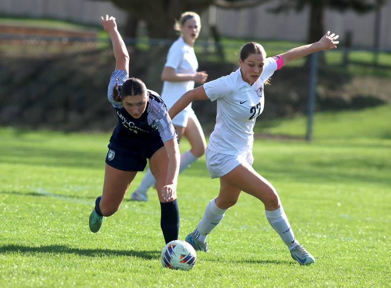 Cary-Grove’s Brynn Harasimowicz, left, battles Prairie Ridge’s Ava Gertz in varsity girls soccer at Cary-Grove High School in Cary on Tuesday, April 29, 2025.