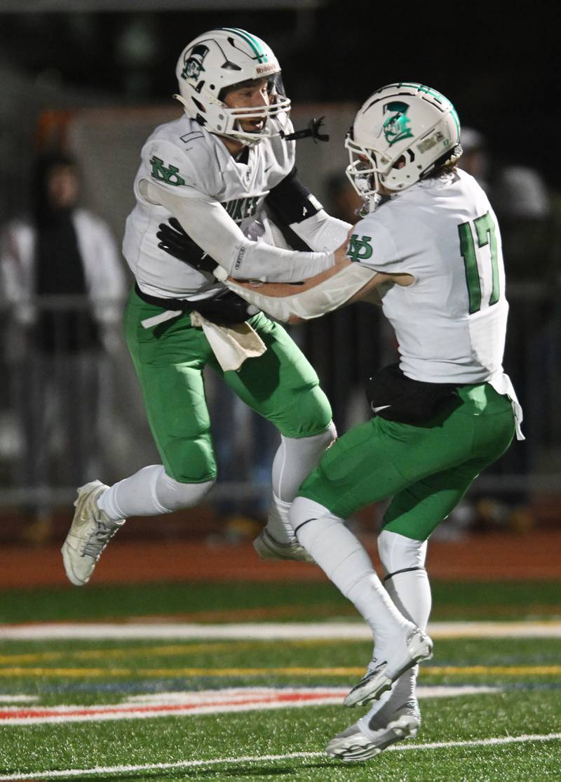 York’s Bruno Massel, left, and Fintan Helm celebrate the Dukes’ 20-15 victory over Naperville Central during the Class 8A football state semifinal on Saturday, Nov. 23, 2024 in Naperville.