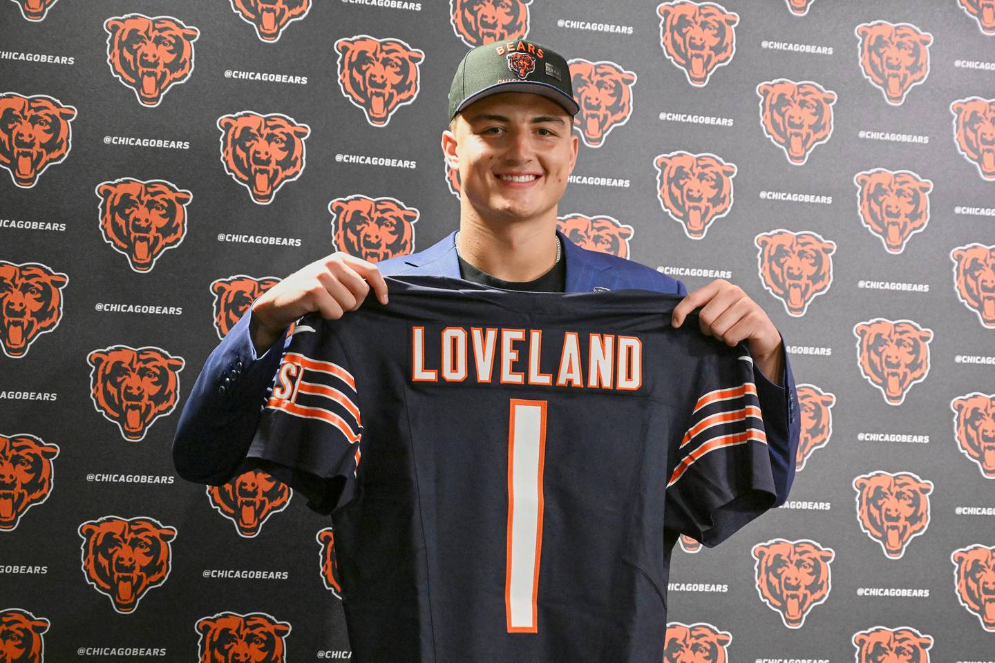 Tight end Colston Loveland, the Chicago Bears' first round draft pick, 10th overall, shows off his jersey during an NFL football press conference, Friday, April 25, 2025, in Lake Forest, Ill. (AP Photo/Matt Marton)